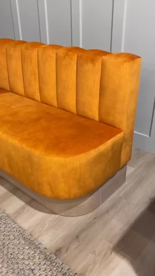 30 Banquette Dining Nook Ideas for Small Kitchens or Corners 3 Mustard yellow velvet curved banquette with vertical channel tufting against gray paneled walls.