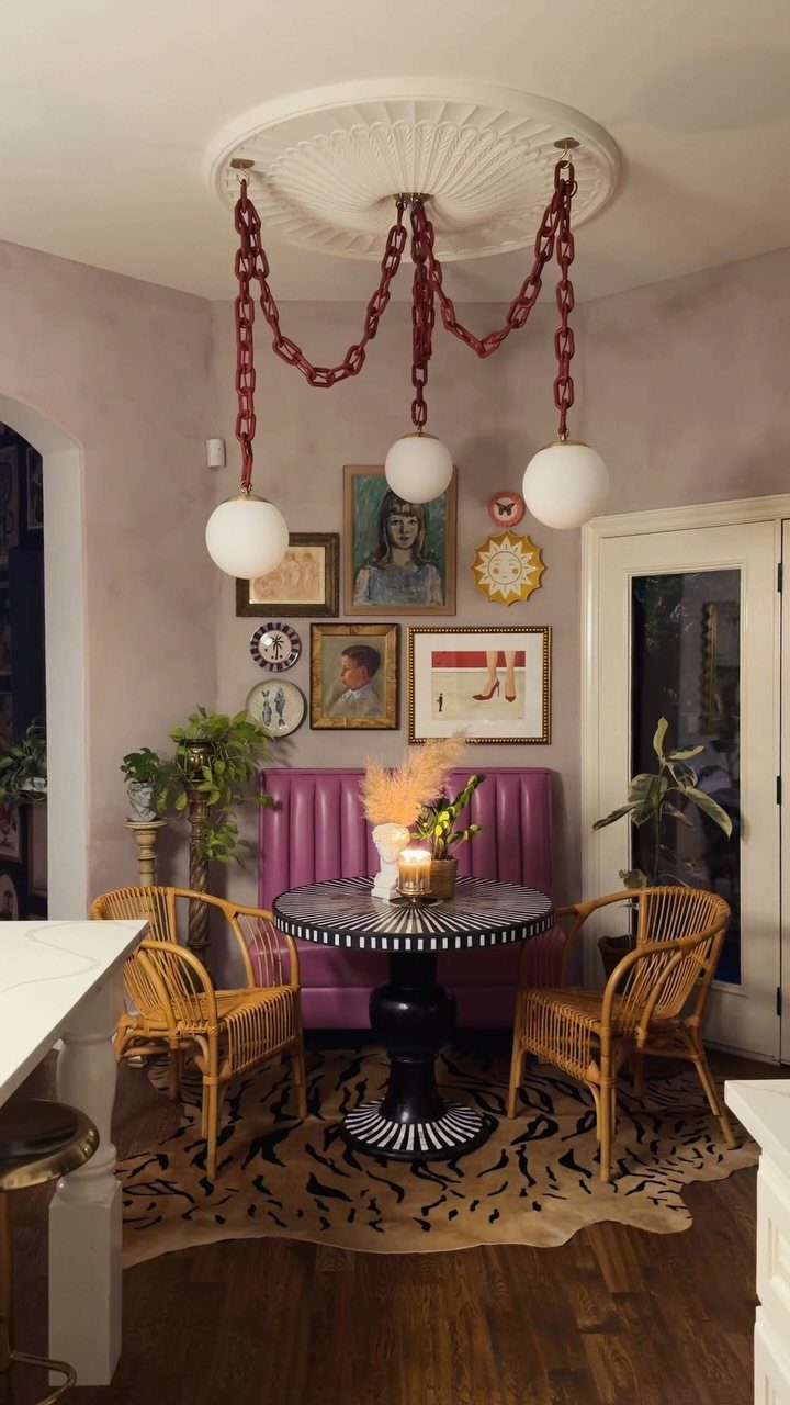 30 Banquette Dining Nook Ideas for Small Kitchens or Corners 21 Purple upholstered banquette and round patterned table with wicker chairs and red chain chandelier