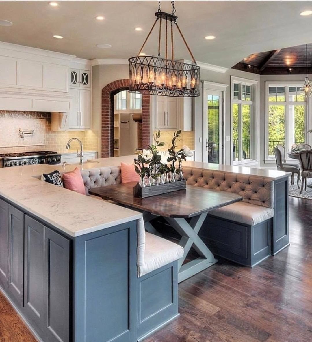 30 Banquette Dining Nook Ideas for Small Kitchens or Corners 14 Blue L-shaped banquette with tufted grey cushions and a dark wood dining table.