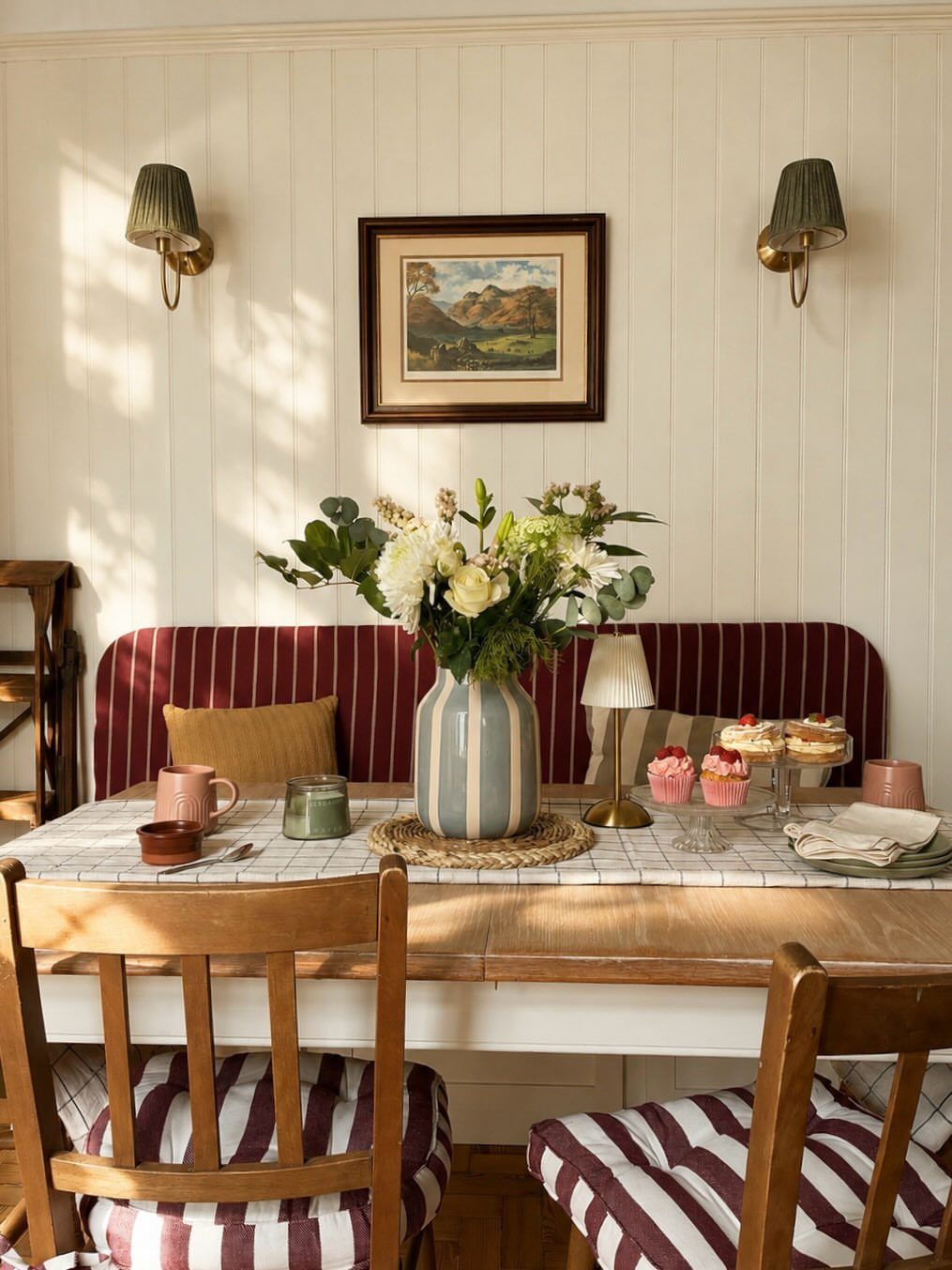 30 Banquette Dining Nook Ideas for Small Kitchens or Corners 13 Red and white striped banquette and chairs in a bright dining nook.