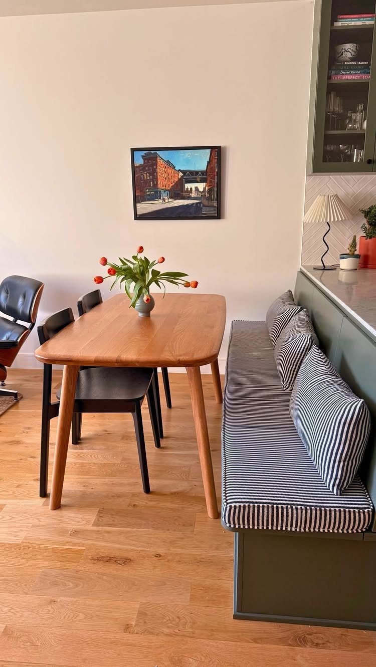 30 Banquette Dining Nook Ideas for Small Kitchens or Corners 8 Green built-in banquette with striped cushions and a light wood dining table.
