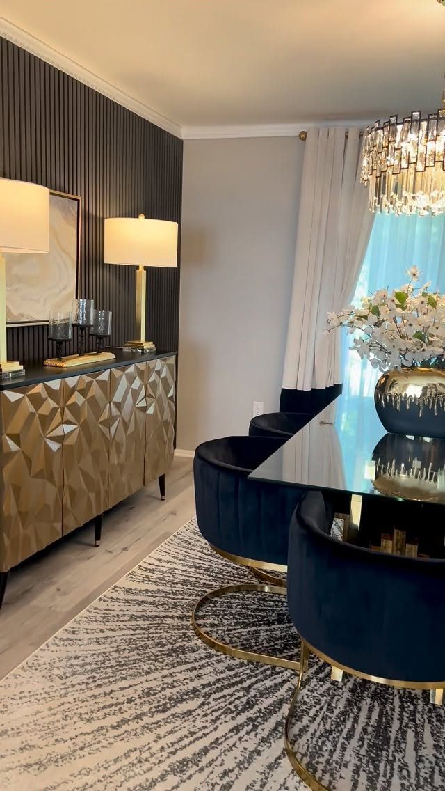 Gold geometric sideboard with two lamps and candles in a modern dining room.