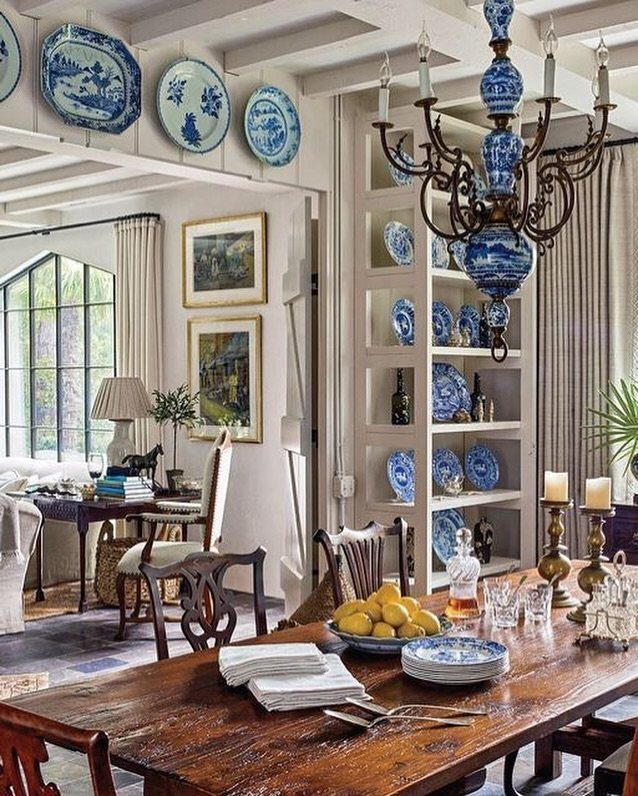 12 Dining Room Decor Hutch Ideas, From Farmhouse to Japandi 10 Rustic dining room with a white hutch filled with blue and white pottery.