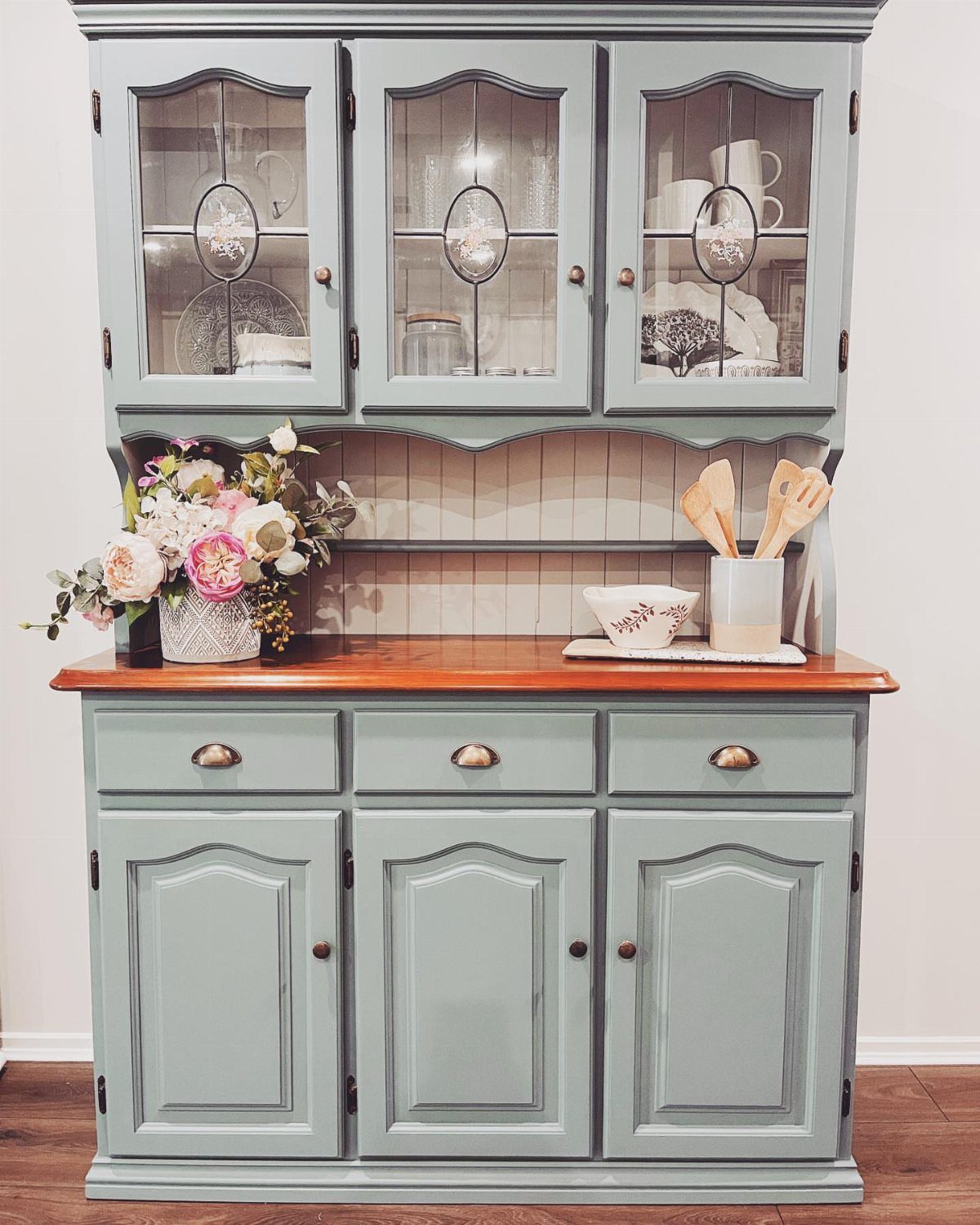 12 Dining Room Decor Hutch Ideas, From Farmhouse to Japandi 11 Sage green dining room hutch with wood top and glass display cabinets.
