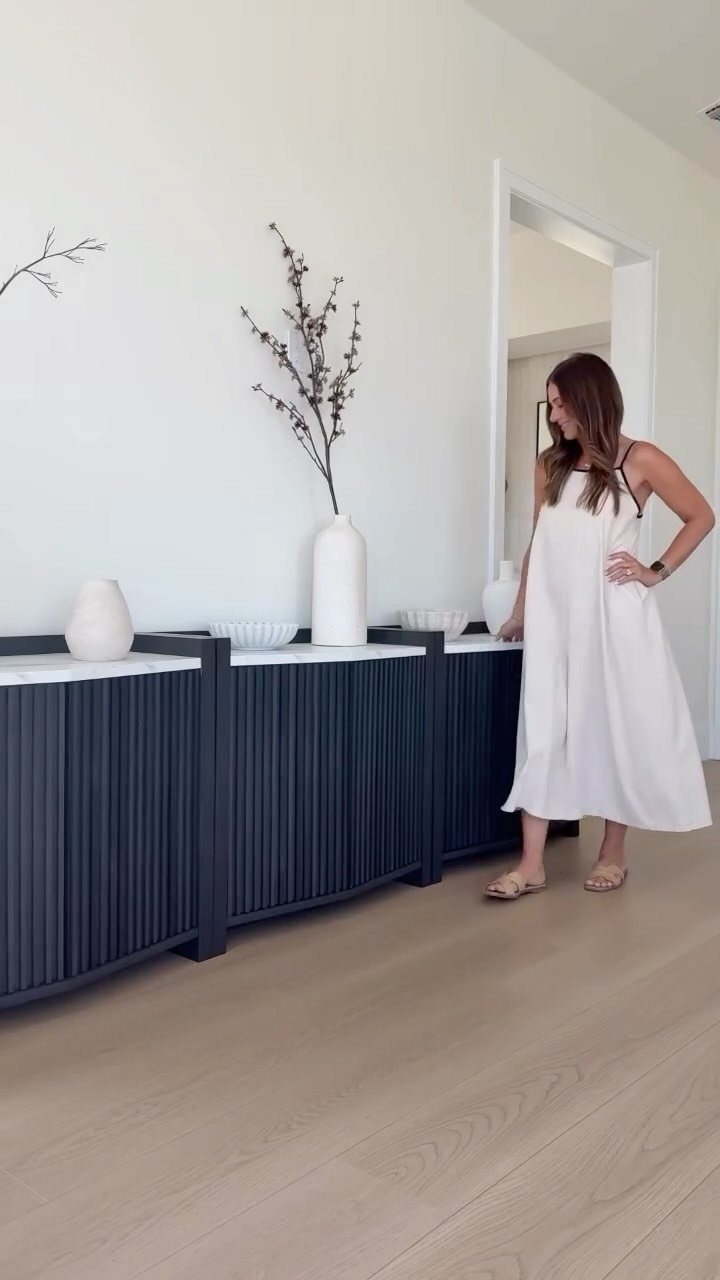 Dining Room Side Cabinet Designs with 18 Stylish Options 4 Modern black fluted sideboard with white marble top in a bright minimalist room.