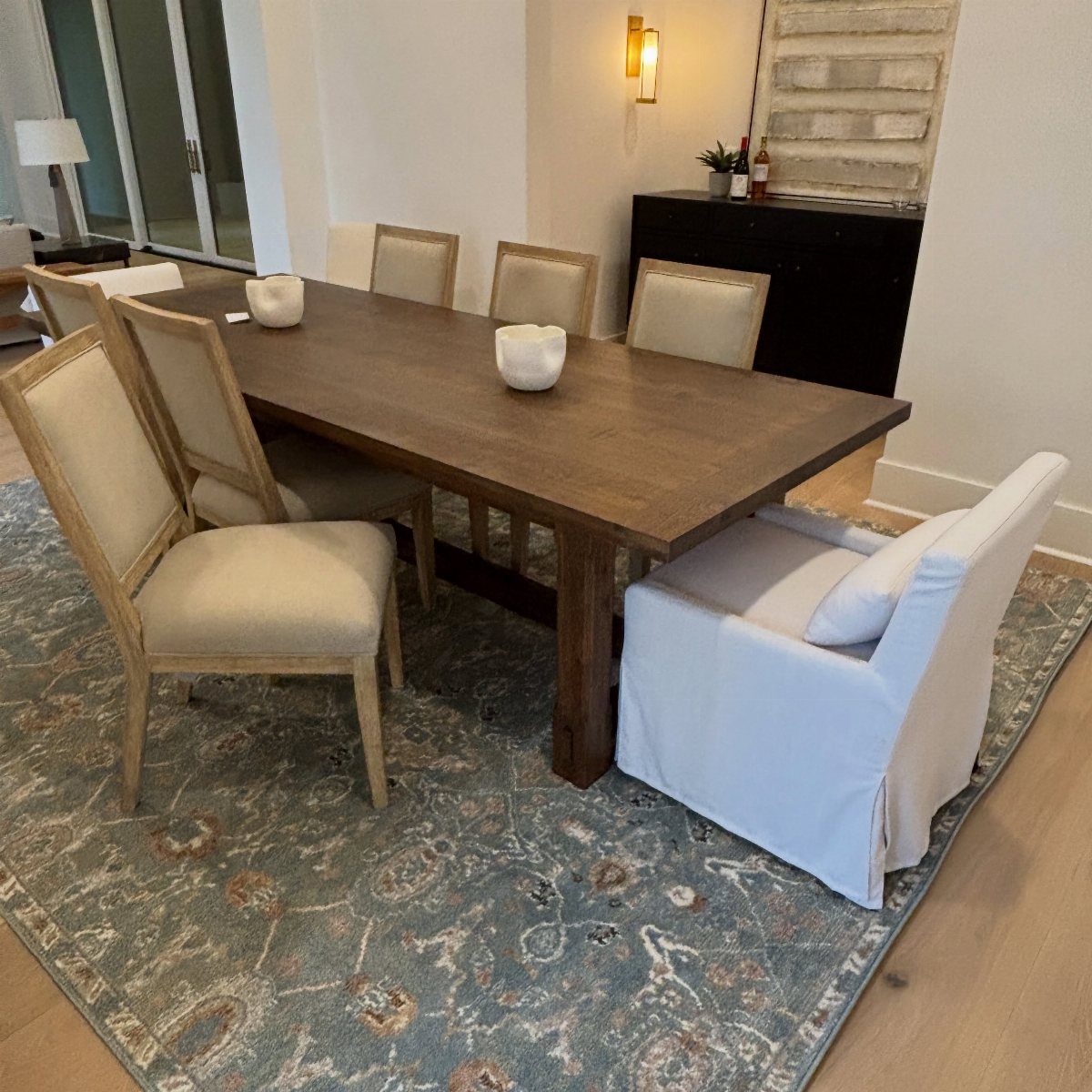 Fabric Chairs Dining Ideas: 32 Styles, Colors, and Frames 32 Wooden dining table with beige upholstered chairs and a white slipcovered armchair.