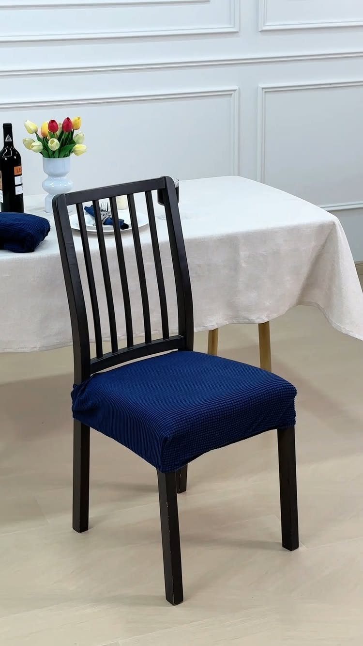 Fabric Chairs Dining Ideas: 32 Styles, Colors, and Frames 29 Dark wood dining chair with a blue fabric seat cover by a white table.