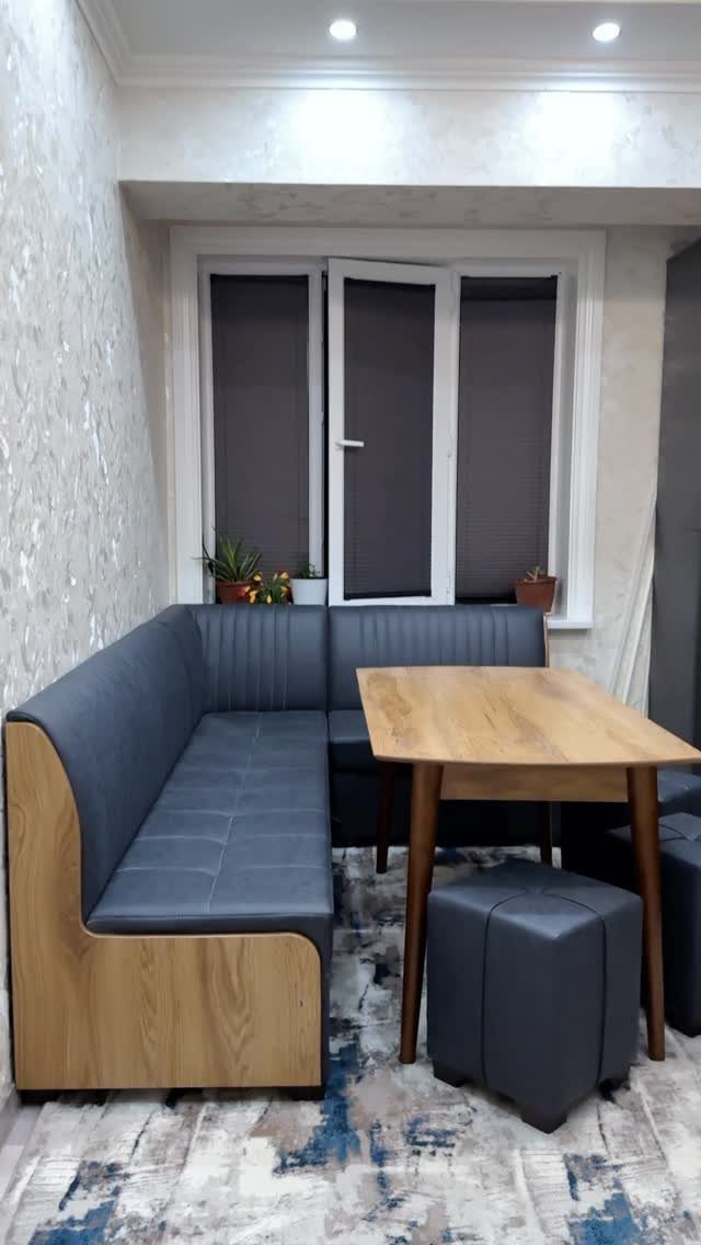 Fabric Chairs Dining Ideas: 32 Styles, Colors, and Frames 26 Gray upholstered L-shaped dining nook with wooden base and a light wood table.