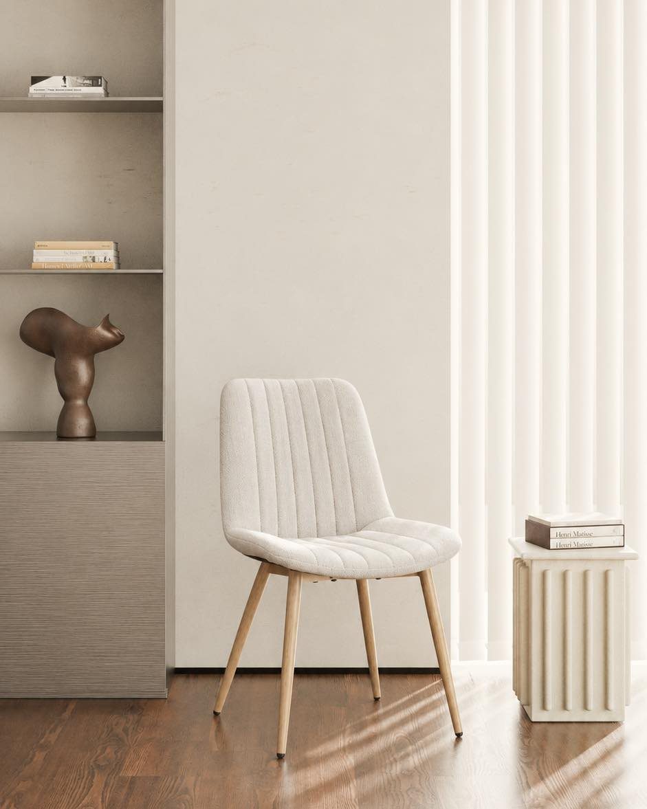 Fabric Chairs Dining Ideas: 32 Styles, Colors, and Frames 17 Off-white upholstered dining chair with vertical stitching and light wood legs in minimalist room.