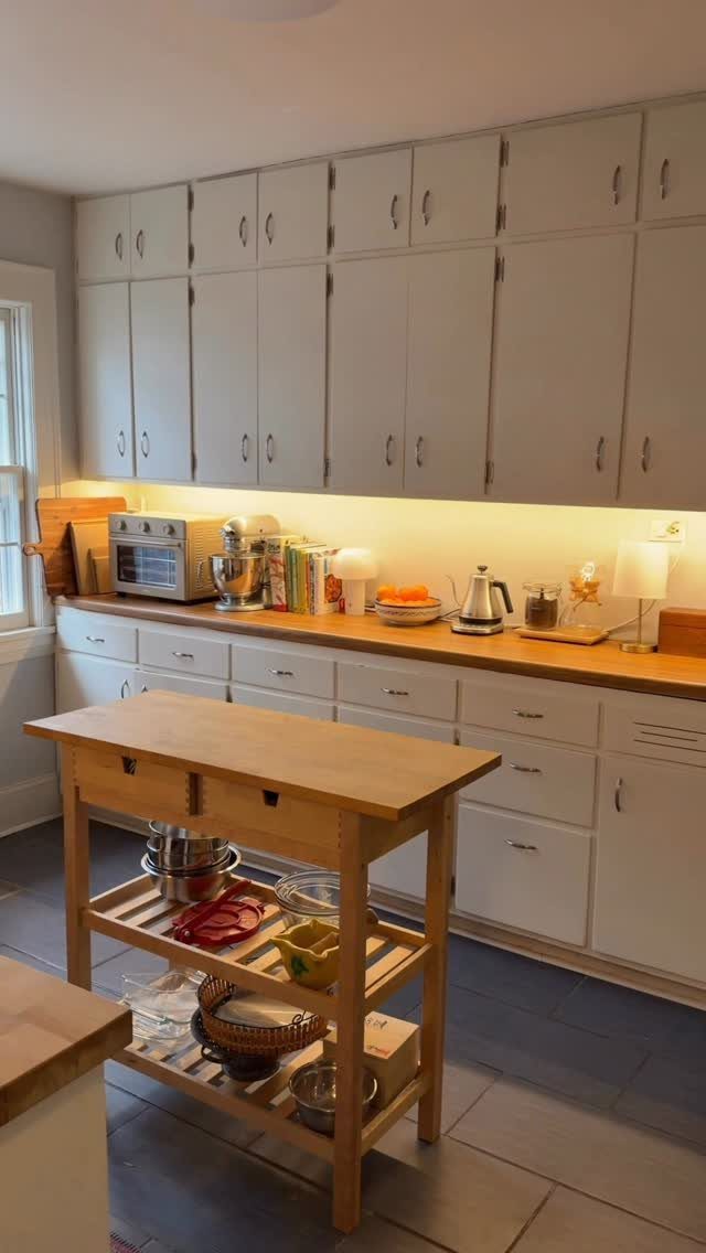 35 Farmhouse Kitchen Remodel Ideas Worth Stealing 9 Butcher block countertops on a kitchen island and wall counter with white cabinetry.