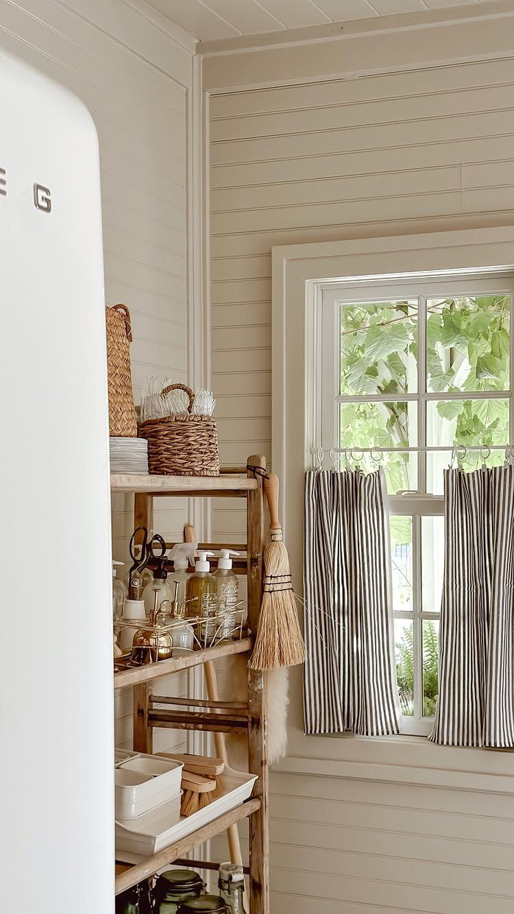 35 Farmhouse Kitchen Remodel Ideas Worth Stealing 35 Striped black and white cafe curtains on a window with white shiplap walls.