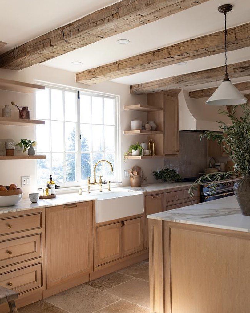 35 Farmhouse Kitchen Remodel Ideas Worth Stealing 17 Rustic exposed wood ceiling beams in a bright farmhouse kitchen with light cabinetry.