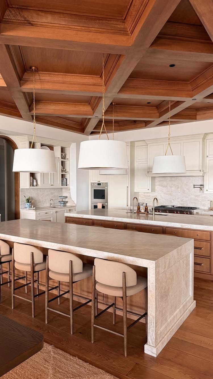 35 Farmhouse Kitchen Remodel Ideas Worth Stealing 28 Three large white pendant lights hanging from a coffered wood kitchen ceiling.