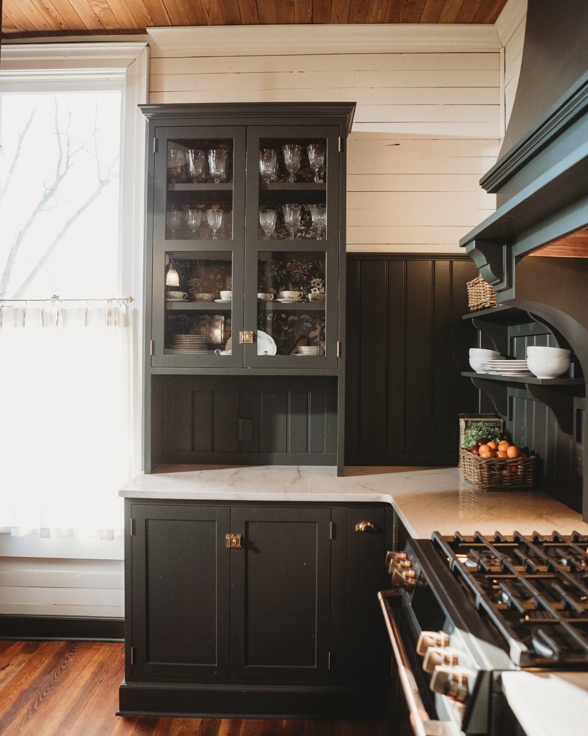 35 Farmhouse Kitchen Remodel Ideas Worth Stealing 25 Dark grey kitchen hutch with glass cabinets and marble countertop against white shiplap walls.