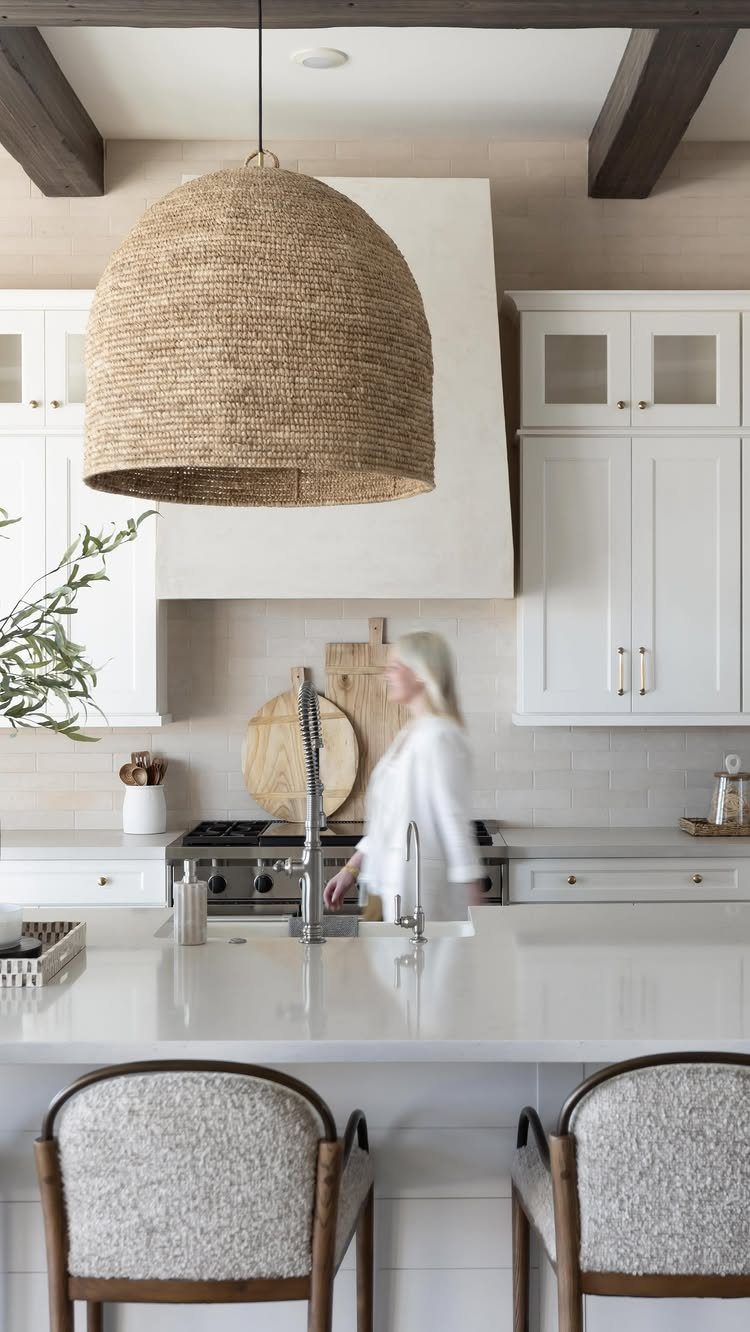 35 Farmhouse Kitchen Remodel Ideas Worth Stealing 10 Large woven wicker dome pendant light hanging over a white marble kitchen island.