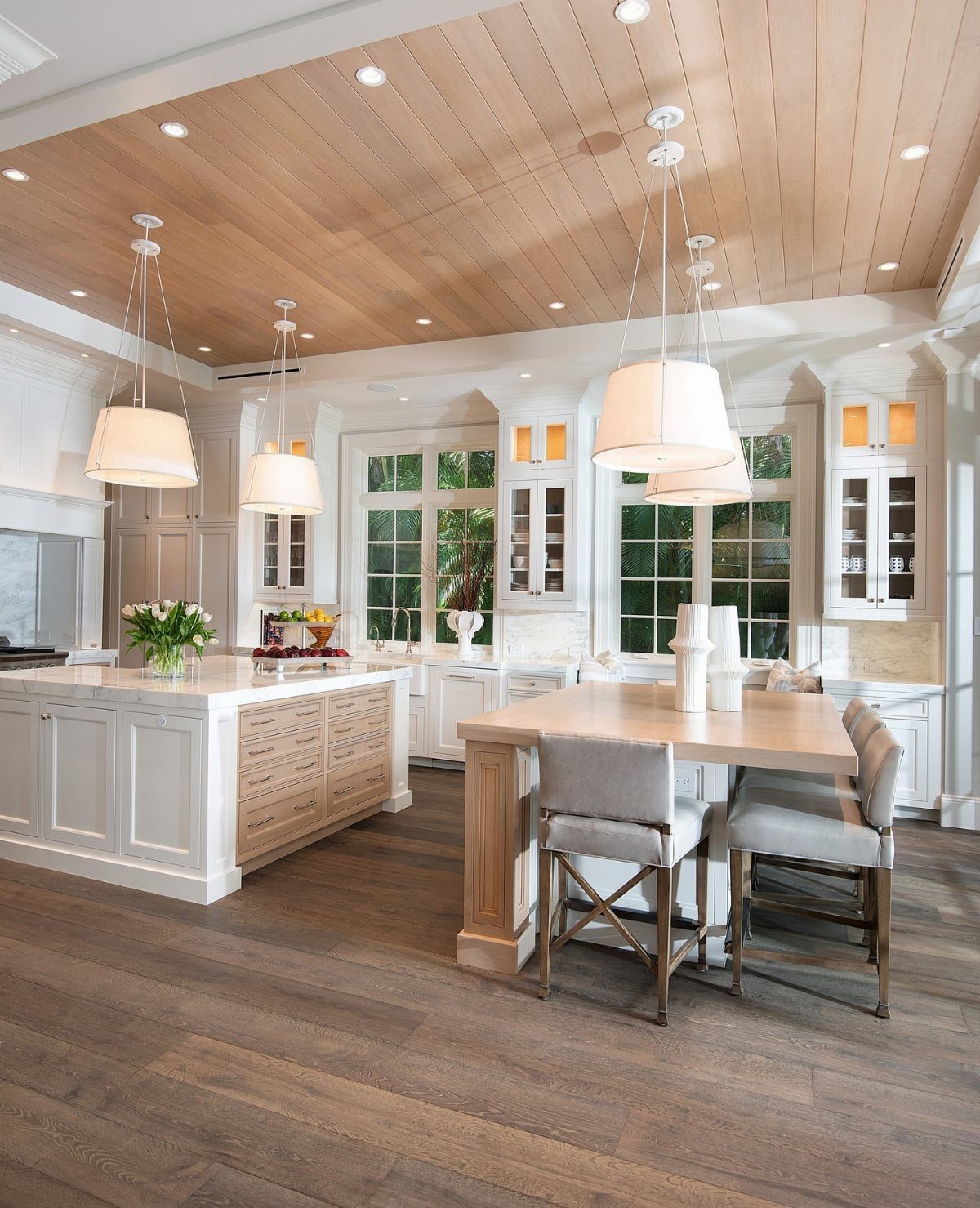35 Farmhouse Kitchen Remodel Ideas Worth Stealing 29 Two kitchen islands, one white and one wood, under a light plank ceiling.