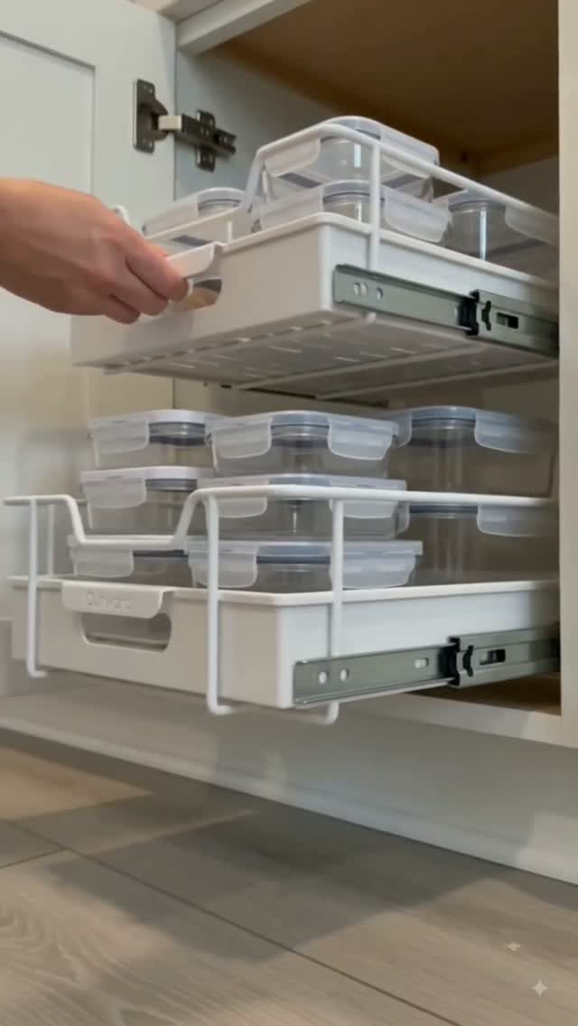 23 Fifth Wheel Remodel Ideas for Storage, Color, and Comfort 1 White pull-out cabinet drawers holding clear plastic food storage containers in a modern kitchen.