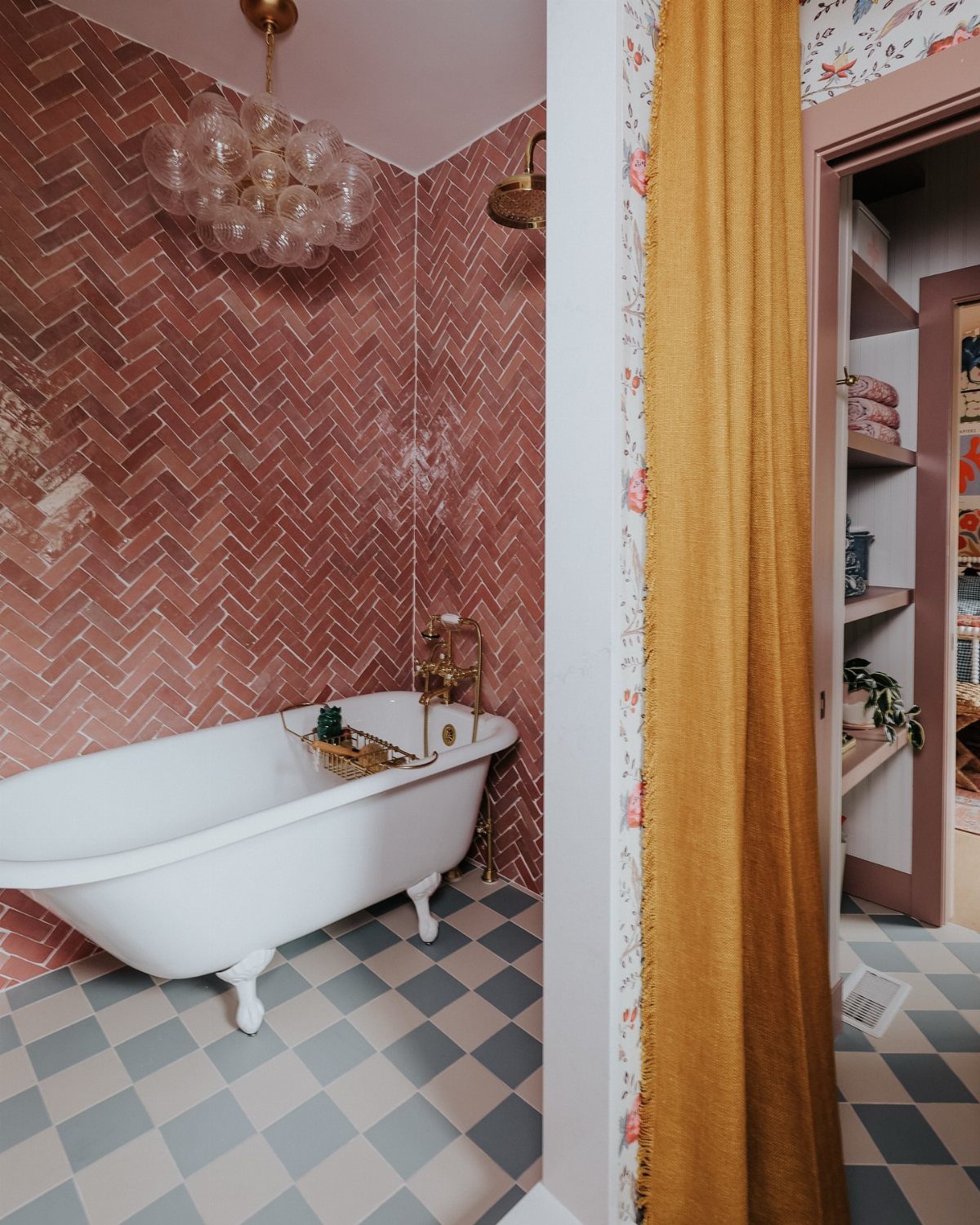 17 Jack and Jill Bathroom Remodel Ideas for Shared Spaces 12 White clawfoot bathtub against pink herringbone tiled walls with a checkered floor.