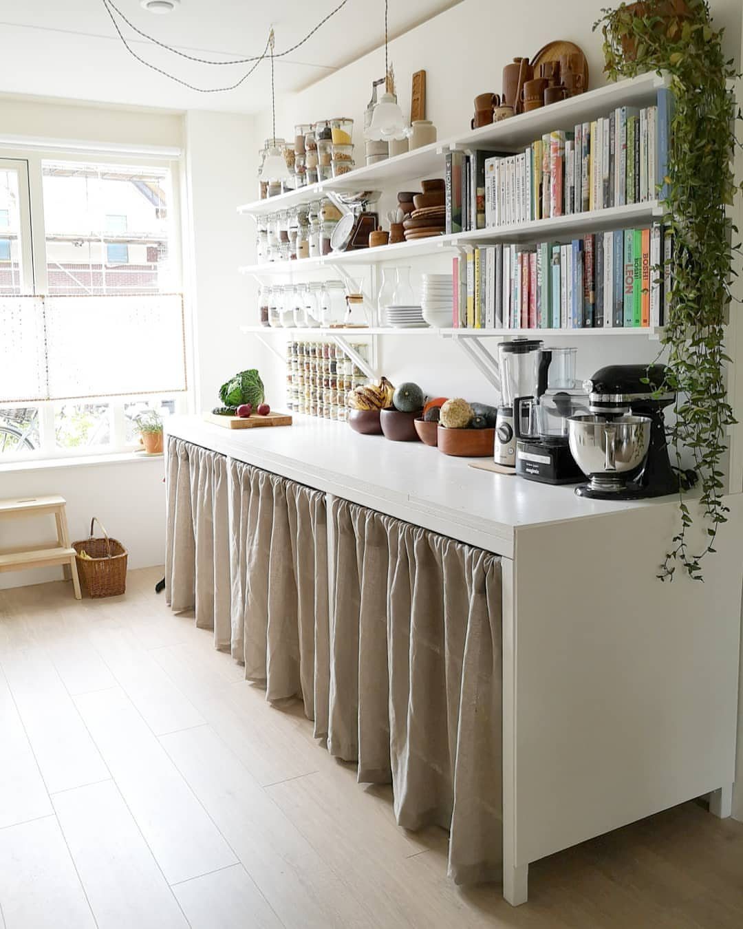 28 Kitchen Cabinets Remodel Ideas and Photos to Try in 2026 1 White open wall shelves with books and jars above a white kitchen counter.