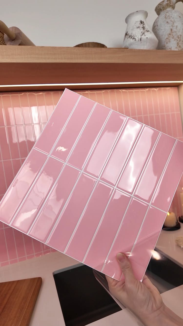 28 Kitchen Cabinets Remodel Ideas and Photos to Try in 2026 20 Pink peel-and-stick backsplash tile sheet held in front of a matching kitchen wall.