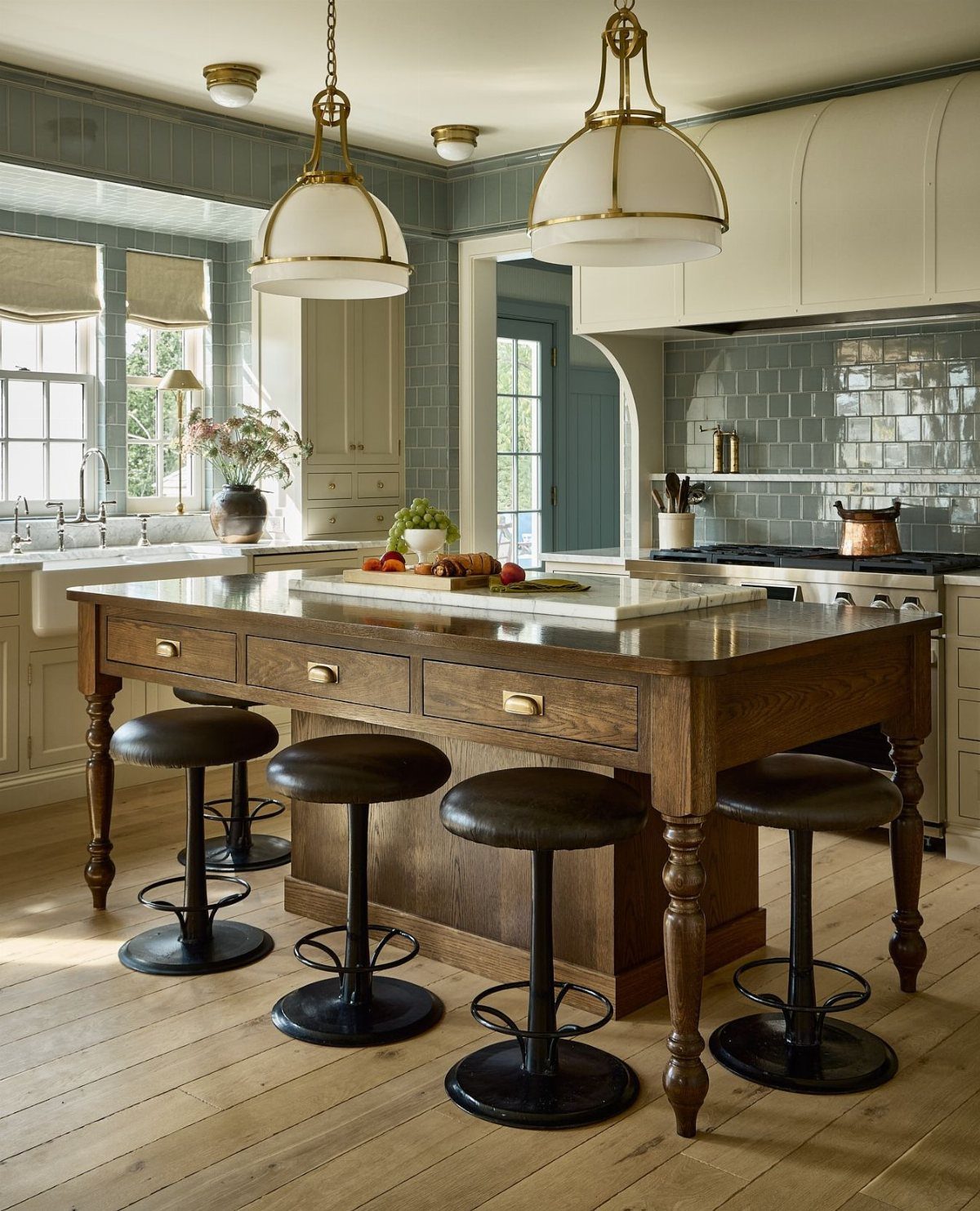 28 Kitchen Cabinets Remodel Ideas and Photos to Try in 2026 28 Wooden baker's table with a white marble slab top and black swivel stools.