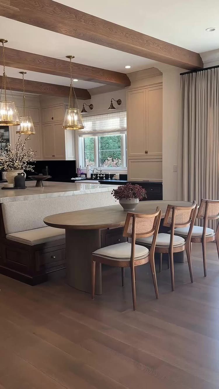 28 Kitchen Cabinets Remodel Ideas and Photos to Try in 2026 27 Banquette seating attached to a white marble kitchen island with an oval wooden table.
