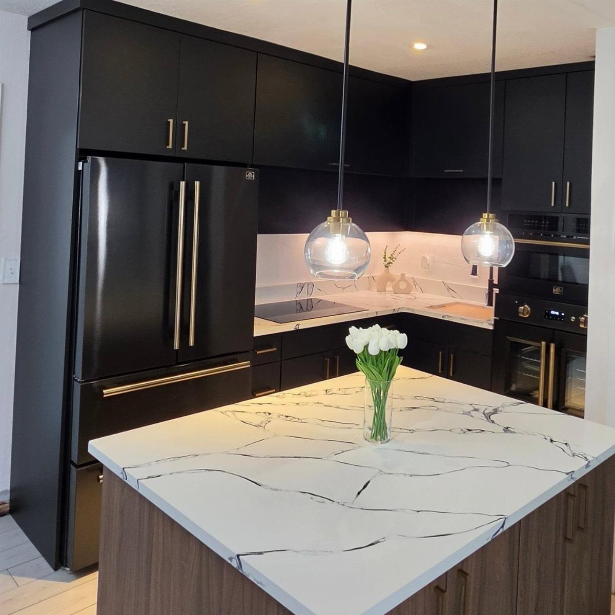 28 Kitchen Cabinets Remodel Ideas and Photos to Try in 2026 15 Matte black kitchen cabinets with gold hardware and a white marble island countertop.