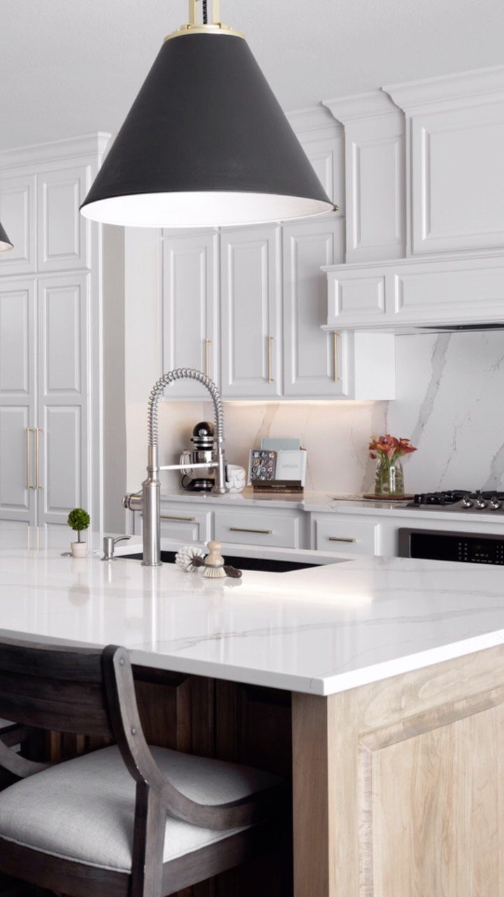 28 Kitchen Cabinets Remodel Ideas and Photos to Try in 2026 18 White quartz countertop on a wooden kitchen island with white shaker cabinets.