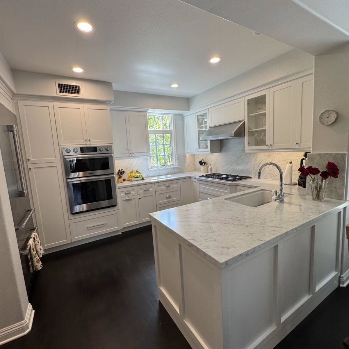 28 Kitchen Cabinets Remodel Ideas and Photos to Try in 2026 4 White shaker-style kitchen cabinets with marble countertops and a large central island.