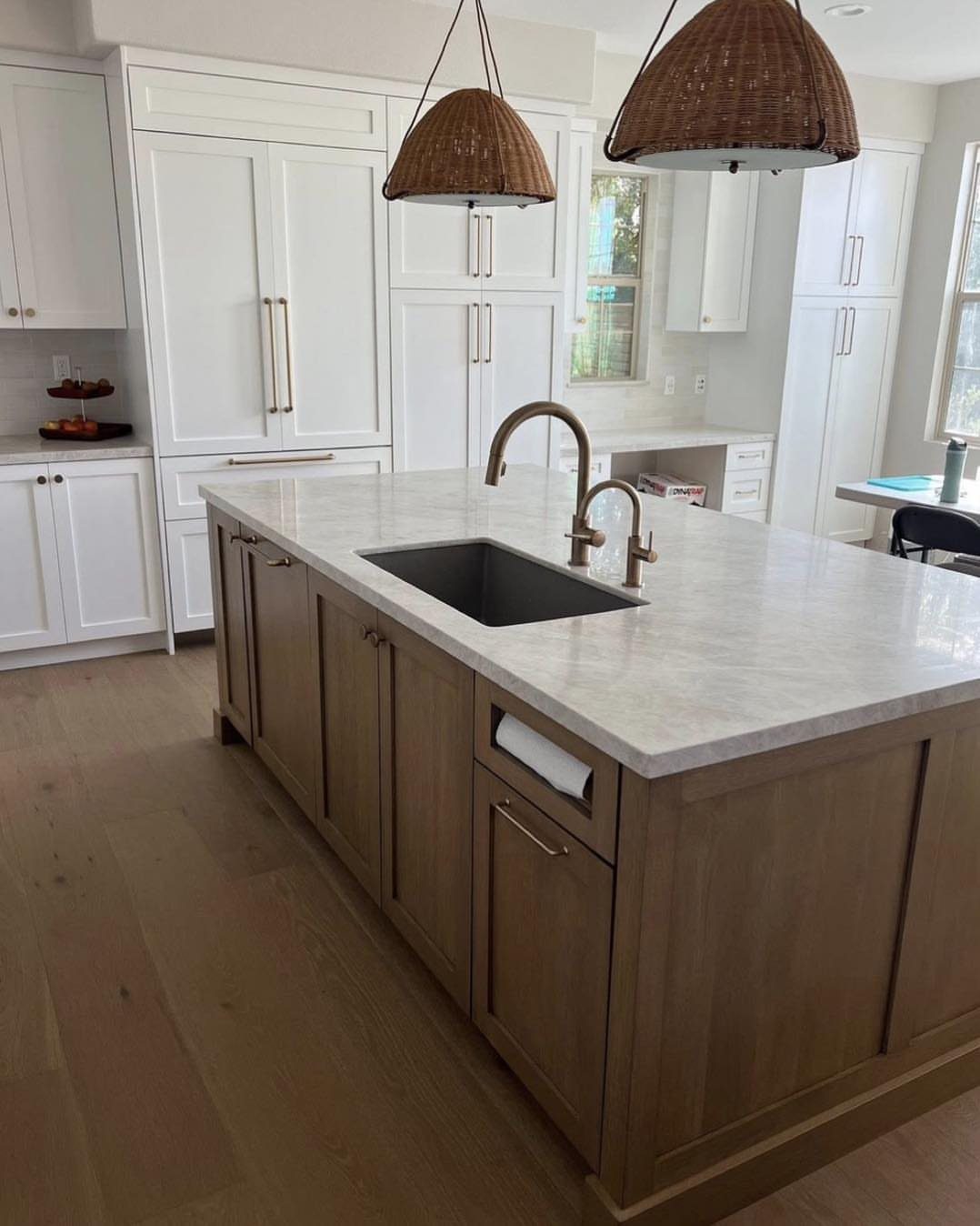 28 Kitchen Cabinets Remodel Ideas and Photos to Try in 2026 10 Kitchen island with light wood cabinets, white marble countertop, and woven pendant lights.