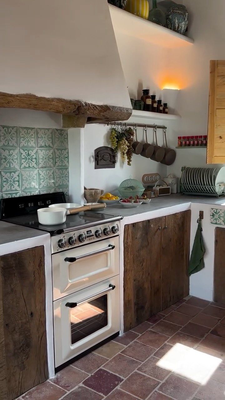 Vintage cream double oven stove in a rustic kitchen with wood cabinets.