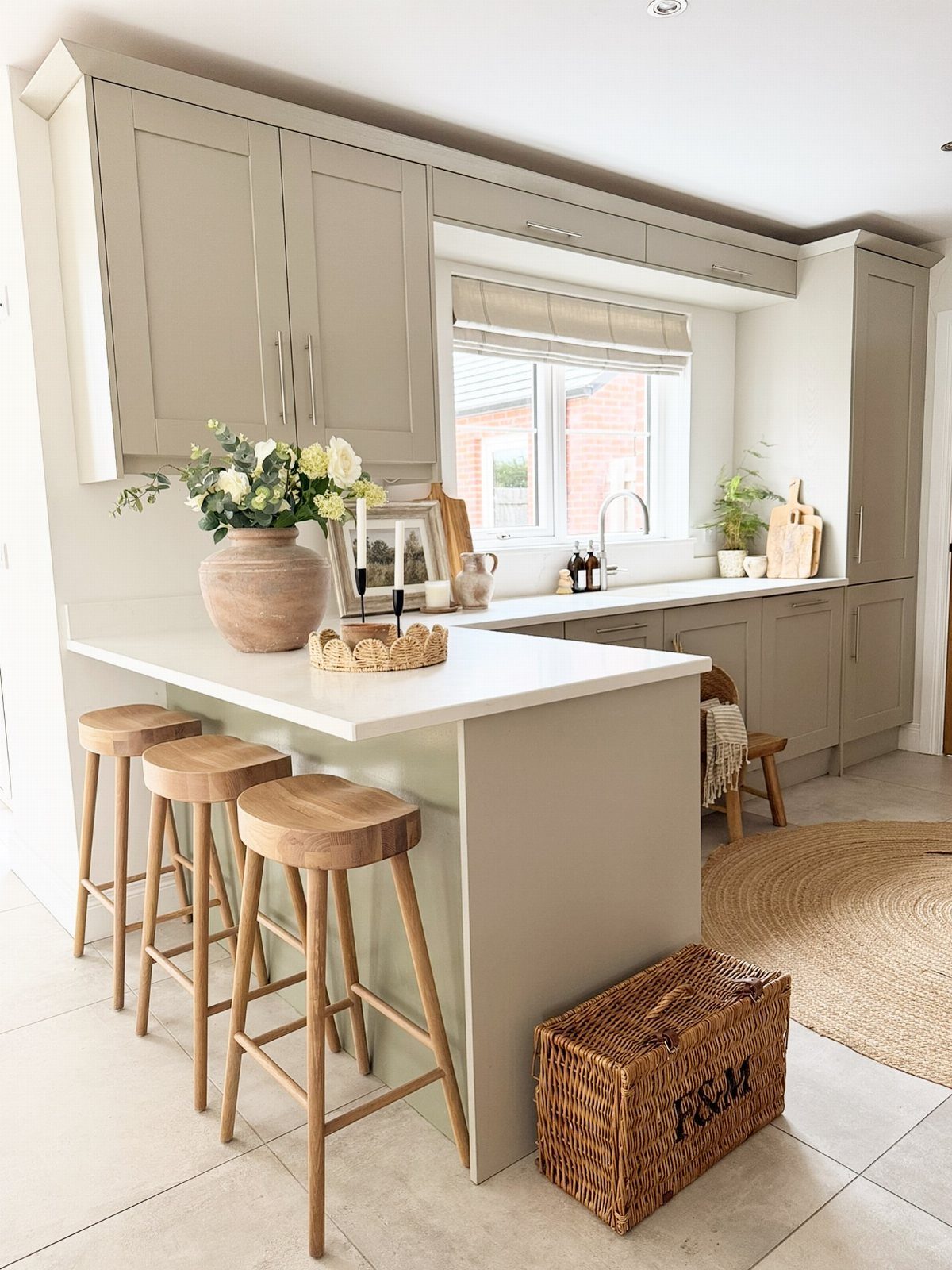 15 Kitchen Style L Shape Ideas, from Islands to Backsplashes 3 White kitchen peninsula with three wooden bar stools in a light grey kitchen