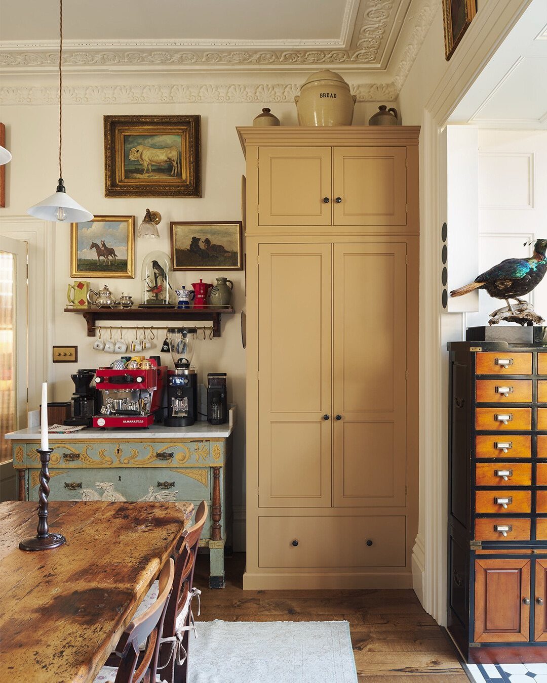 15 Kitchen Style L Shape Ideas, from Islands to Backsplashes 13 Weathered wooden farmhouse table in a rustic kitchen with vintage cabinetry and art.