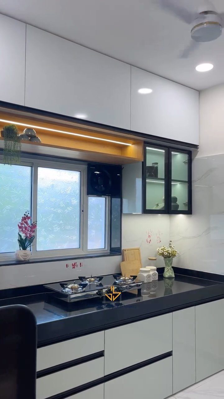 15 Kitchen Style L Shape Ideas, from Islands to Backsplashes 7 Modern white kitchen cabinets with black trim and glass-front upper storage doors.