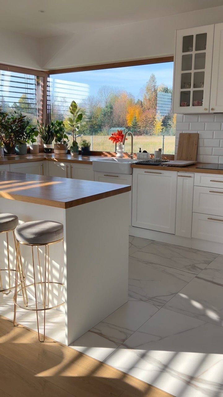 15 Kitchen Style L Shape Ideas, from Islands to Backsplashes 4 L-shaped kitchen peninsula with white cabinets, wooden countertops, and gold bar stools.