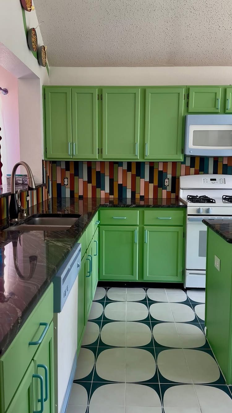 15 Kitchen Style L Shape Ideas, from Islands to Backsplashes 11 Green kitchen cabinets with a bold, colorful geometric tiled backsplash and patterned flooring.
