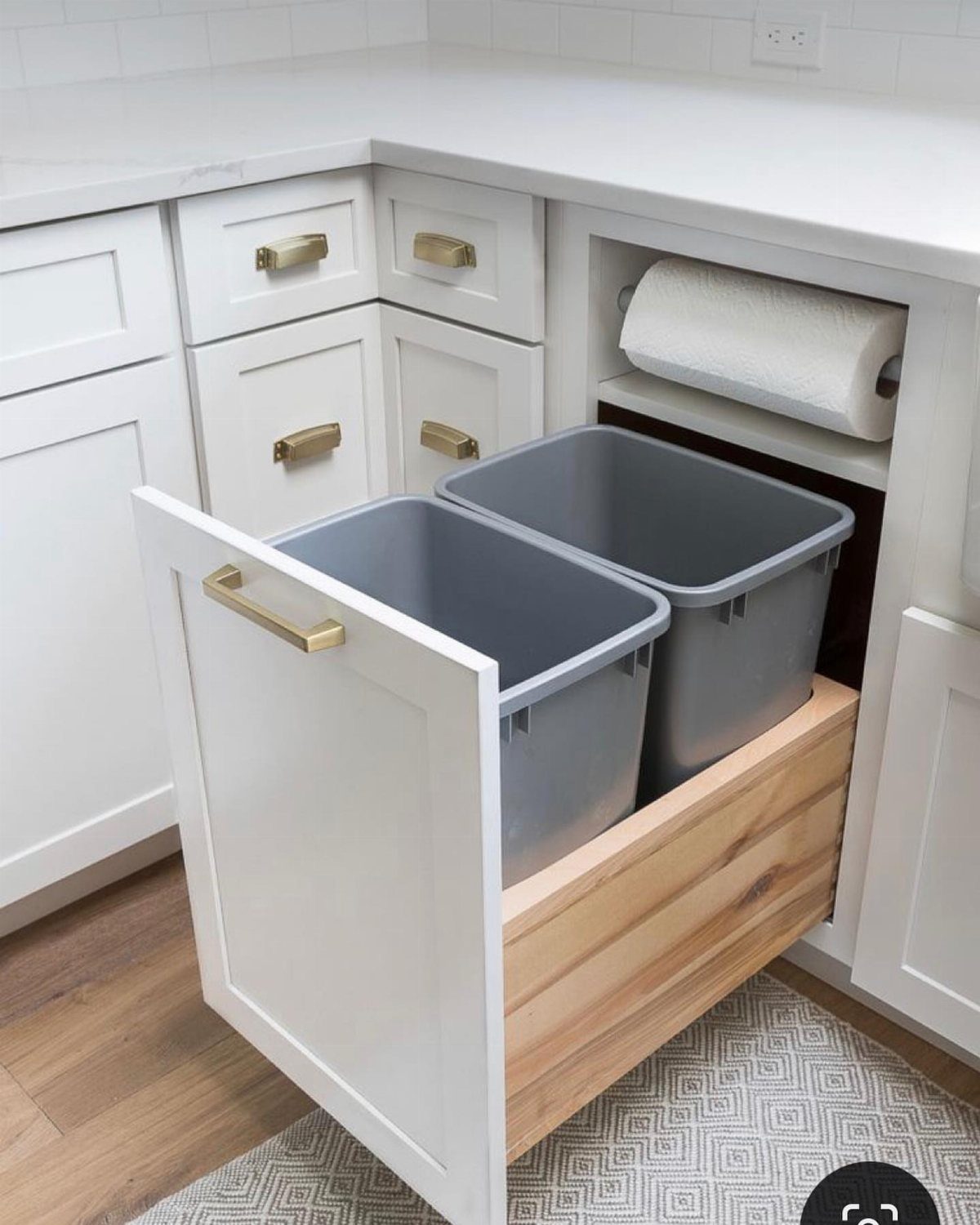 12 Kitchen Updates on a Budget, From Hardware to Pantry Jars 4 Pull-out wooden drawer with two grey bins inside a white kitchen cabinet.