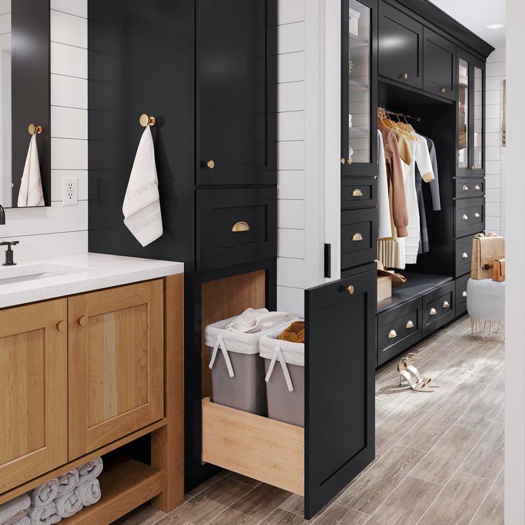 Modern bathroom vanity and black built-in closet with gold hardware and white shiplap walls.