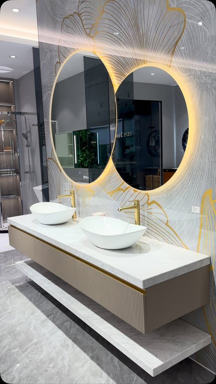 Floating double vanity with white vessel sinks and oval backlit mirrors in modern bathroom.