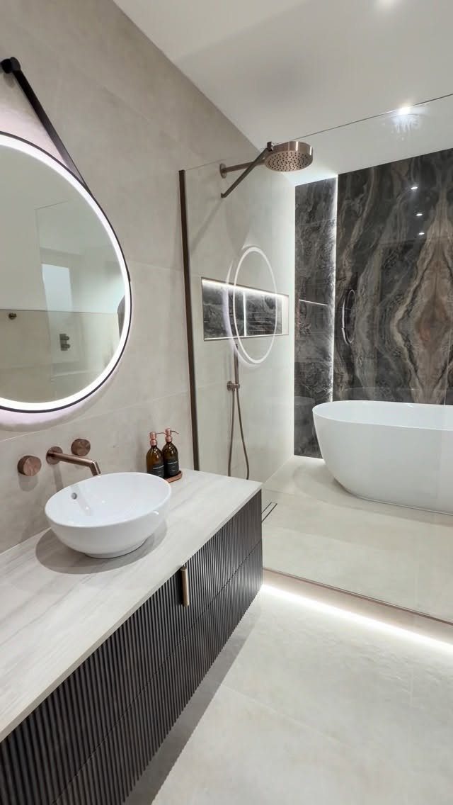 Modern bathroom with a freestanding tub and shower in a tiled wet room area.