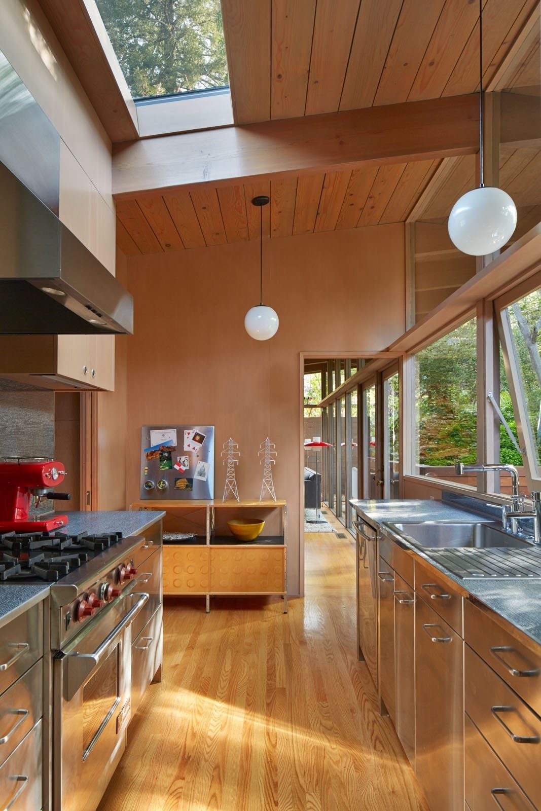 10 Mid Century Modern Kitchen Remodel Ideas for Your Home 6 Stainless steel kitchen cabinets and grey thin square-edge countertops under a wood ceiling.