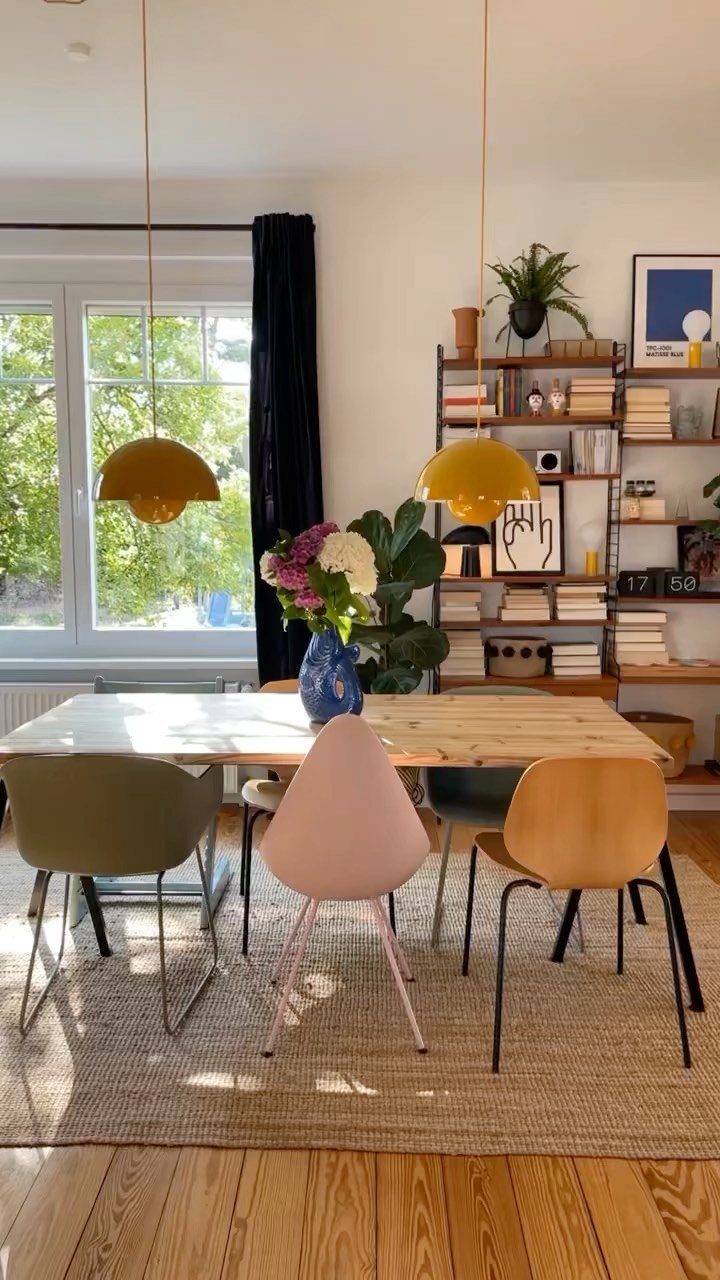Mismatched Chairs Dining Table: 12 Ideas for a Cohesive Look 11 Mismatched colorful dining chairs around a light wood table in a bright room.
