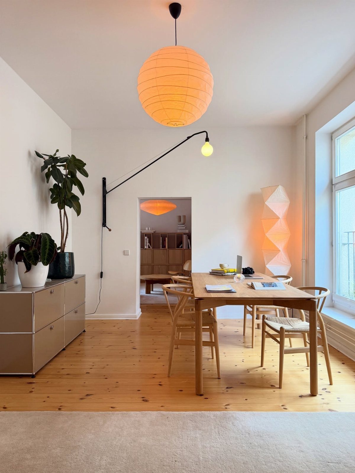 Mismatched Chairs Dining Table: 12 Ideas for a Cohesive Look 6 Light wood dining table and chairs in a bright room with orange lantern