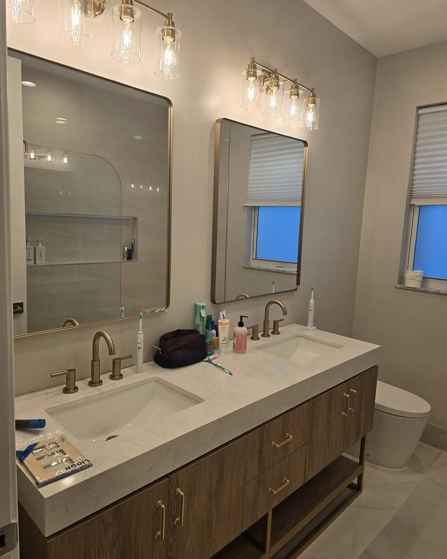 12 Mobile Home Master Bath Remodel Ideas and Moisture Tips 8 Double vanity with two white sinks, marble countertop, and gold-framed mirrors in a bathroom.