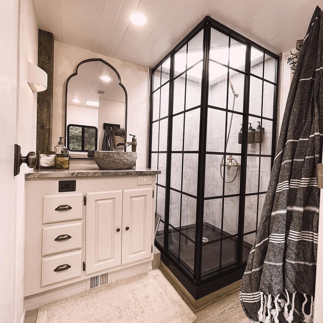 12 Mobile Home Master Bath Remodel Ideas and Moisture Tips 5 White bathroom vanity and black grid shower enclosure in a modern remodeled bathroom