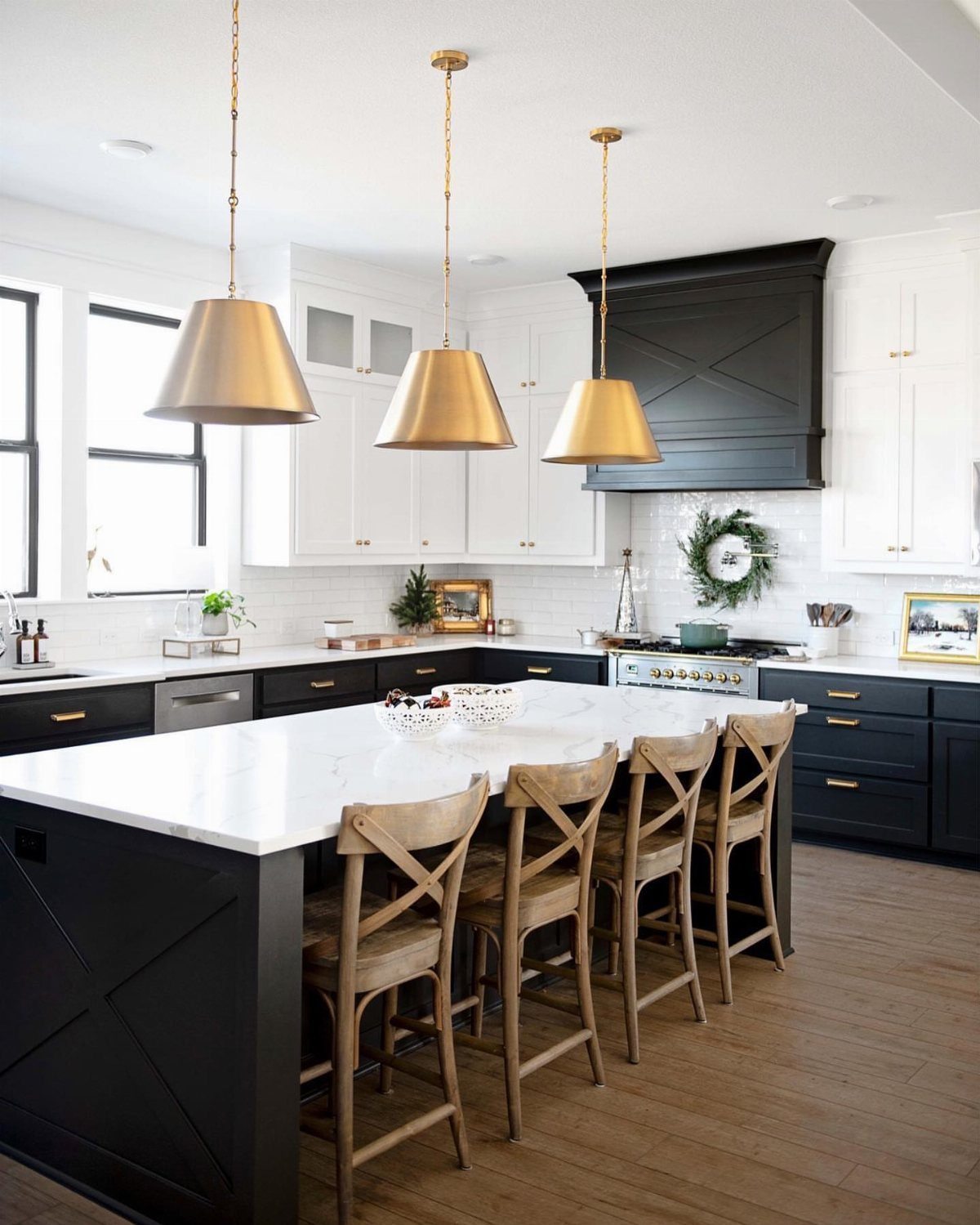 Neutral Kitchen Cabinets: 16 Colors From Greige to Black 14 White and black kitchen cabinets with a marble island and gold pendant lights.