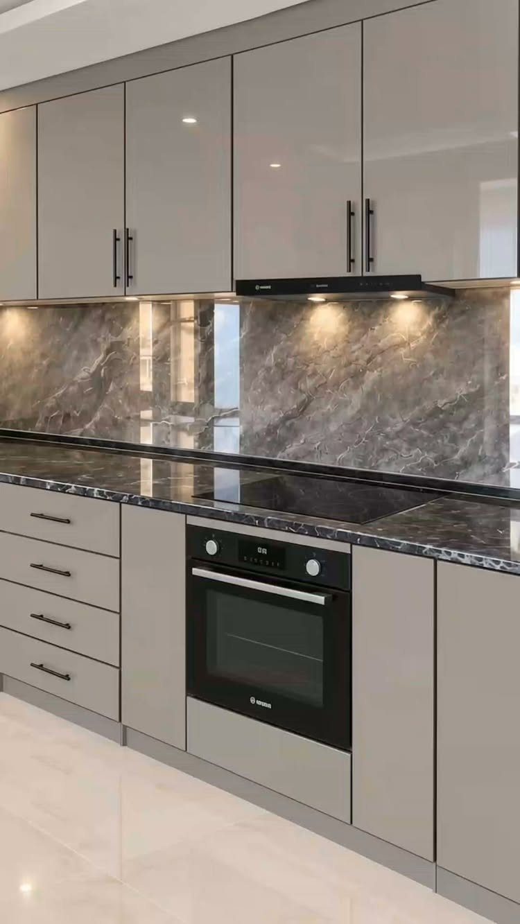 Neutral Kitchen Cabinets: 16 Colors From Greige to Black 1 Greige kitchen cabinets with black hardware and a grey marble backsplash and countertop.
