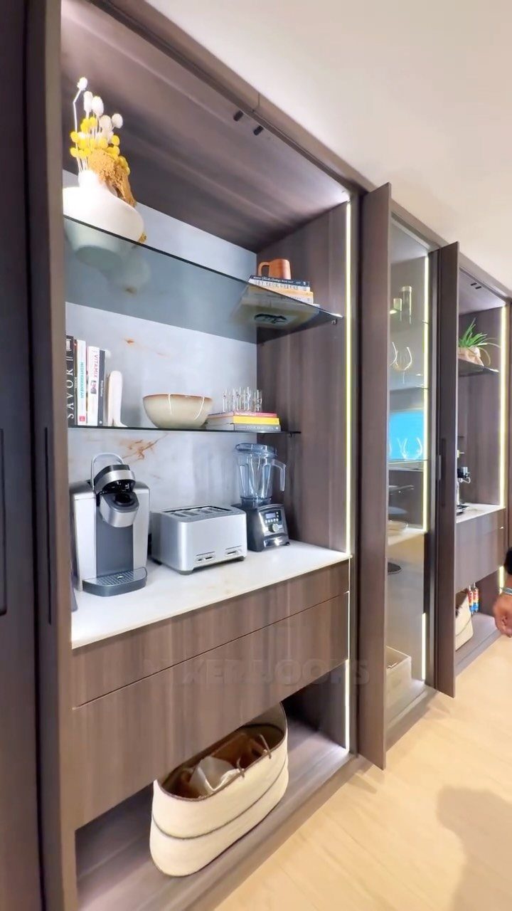 Modern kitchen storage unit with brown cabinets and sliding pocket doors.