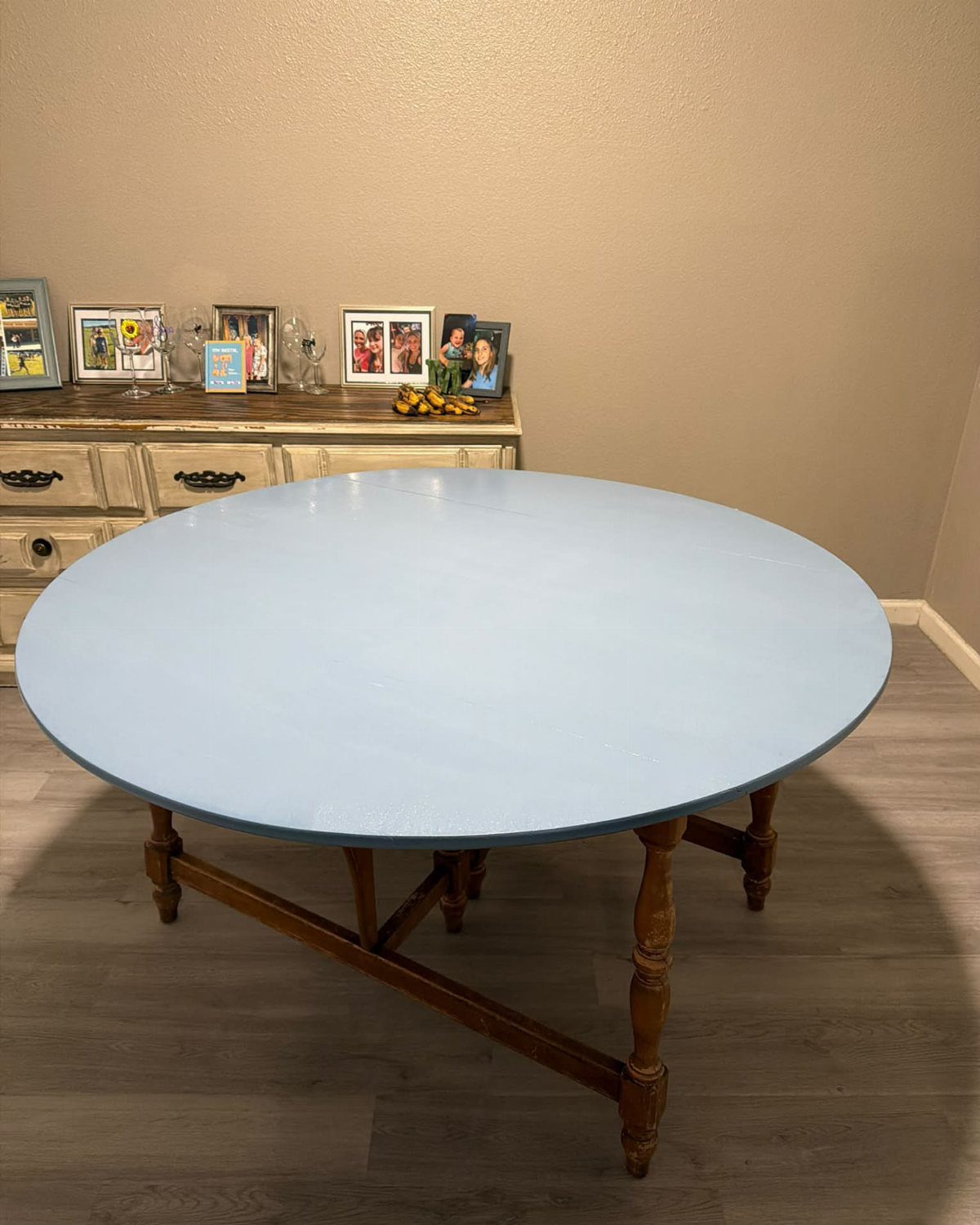 Painting Kitchen Table Ideas: 11 Looks From Yellow to Black 8 Round wooden table with a light blue painted top and natural wood legs.