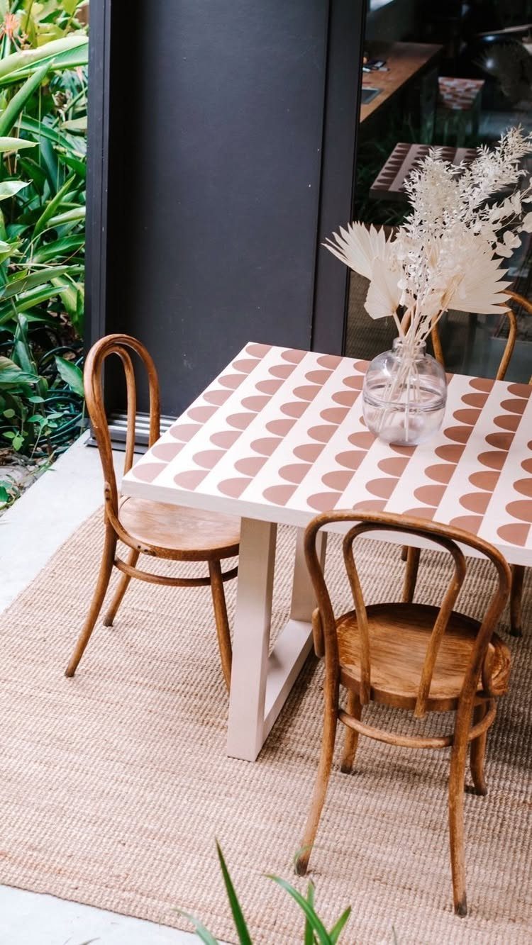 Painting Kitchen Table Ideas: 11 Looks From Yellow to Black 2 White kitchen table with brown semi-circle stenciled patterns and two wooden chairs.